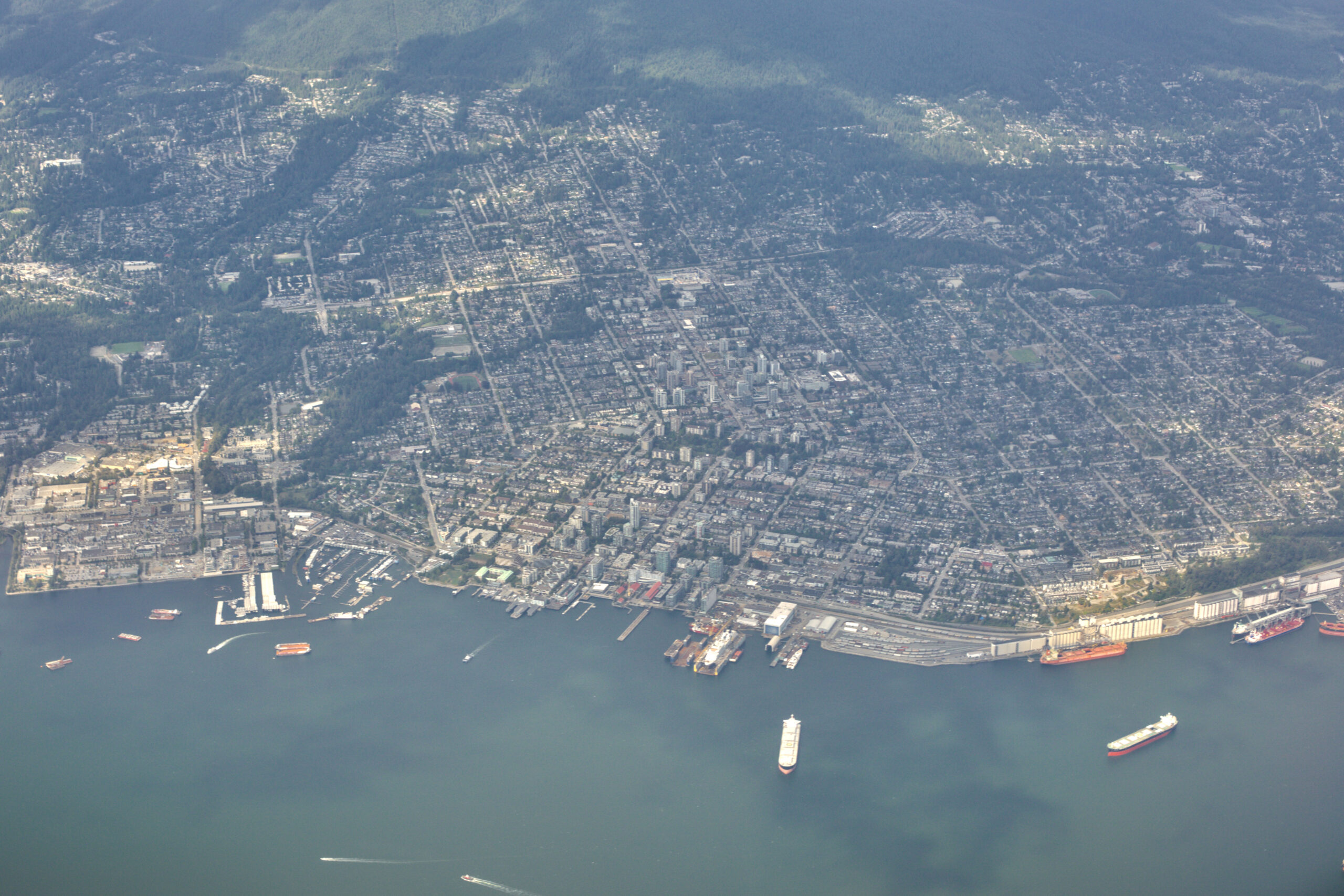 Aerial view of the City of North Vancouver, from the Lonsdale waterfront up toward the North Shore mountains